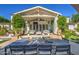 Outdoor patio dining area with a built in veranda, a blue table and white cushioned chairs at 5819 E Calle Del Media --, Phoenix, AZ 85018