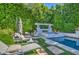 Swimming pool area surrounded by lush greenery featuring a jacuzzi and an outdoor seating area at 5819 E Calle Del Media --, Phoenix, AZ 85018