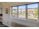 Window view of a peaceful neighborhood with palm trees and mountain backdrop under a clear blue sky at 5819 E Calle Del Media --, Phoenix, AZ 85018