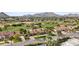 Beautiful aerial view of a home with green grass, palm trees, and scenic mountain views at 5827 E Sanna St, Paradise Valley, AZ 85253