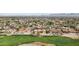 Beautiful aerial showcasing the lush golf course, nearby housing, and distant mountain views at 5827 E Sanna St, Paradise Valley, AZ 85253