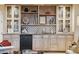 Butler's pantry boasts open shelving, glass front cabinets, mini fridge and a checkered backsplash at 5827 E Sanna St, Paradise Valley, AZ 85253