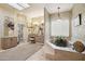 Luxurious bathroom with a soaking tub, vanity area, and decorative wallpaper at 5827 E Sanna St, Paradise Valley, AZ 85253