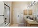 Bathroom features a shower/tub combo with framed glass, a granite vanity, and oak cabinets at 5827 E Sanna St, Paradise Valley, AZ 85253