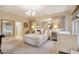 Comfortable bedroom featuring a plush bed, mirrored accent wall, and ambient lighting at 5827 E Sanna St, Paradise Valley, AZ 85253