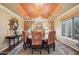 Formal dining room featuring a chandelier, custom ceiling, and elegant curtains at 5827 E Sanna St, Paradise Valley, AZ 85253