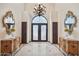 Grand foyer featuring decorative mirrors, chandelier, and intricate wrought iron doors at 5827 E Sanna St, Paradise Valley, AZ 85253