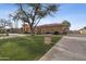 Well-manicured lawn and mature landscaping enhance this home with a spacious driveway and timeless design at 5827 E Sanna St, Paradise Valley, AZ 85253