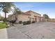 Home featuring a spacious three-car garage with a concrete driveway, complemented by lush greenery and mature trees at 5827 E Sanna St, Paradise Valley, AZ 85253