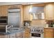 Close up of well-equipped kitchen featuring granite counters, a stainless steel range, and custom cabinetry at 5827 E Sanna St, Paradise Valley, AZ 85253