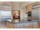 Kitchen view featuring a center island with sink, stainless steel appliances, and custom cabinetry at 5827 E Sanna St, Paradise Valley, AZ 85253