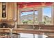 Kitchen showcasing a large window with scenic mountain views, granite countertops and wood cabinets at 5827 E Sanna St, Paradise Valley, AZ 85253