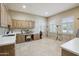 Spacious laundry room with ample storage, a utility sink, and multiple windows at 5827 E Sanna St, Paradise Valley, AZ 85253