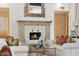 Elegant living room featuring a fireplace with tile surround, sofas, and a decorative mirror at 5827 E Sanna St, Paradise Valley, AZ 85253