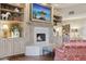 Cozy living room showing a fireplace surrounded by built-in cabinets and an upholstered chair at 5827 E Sanna St, Paradise Valley, AZ 85253