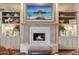 Elegant living room features a fireplace, custom built-ins, and a serene beach scene above the mantle at 5827 E Sanna St, Paradise Valley, AZ 85253