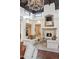 Bright living room with fireplace, coffered ceiling, modern light fixture, and tile flooring at 5827 E Sanna St, Paradise Valley, AZ 85253