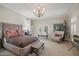 Beautiful main bedroom with a large bed, seating and french doors to the exterior at 5827 E Sanna St, Paradise Valley, AZ 85253