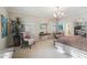 Spacious main bedroom with chandelier, sitting area, two windows with shutters, and ensuite bathroom access at 5827 E Sanna St, Paradise Valley, AZ 85253