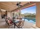 Covered outdoor patio with dining set overlooking a pool and lush green landscape at 5827 E Sanna St, Paradise Valley, AZ 85253