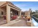 Relaxing outdoor patio featuring comfortable seating, stone flooring, and a charming fireplace for cozy evenings at 5827 E Sanna St, Paradise Valley, AZ 85253