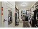 Spacious walk-in closet with custom shelving, drawers, and ample storage space for clothing and accessories at 5827 E Sanna St, Paradise Valley, AZ 85253