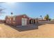 Back exterior of home featuring a spacious dirt backyard, and a covered patio at 5952 W Coronado Rd, Phoenix, AZ 85035