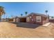 Back exterior of home featuring a spacious dirt backyard, and a covered patio at 5952 W Coronado Rd, Phoenix, AZ 85035