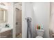 A full bathroom features tiled shower, wooden mirror, and modern vanity at 5952 W Coronado Rd, Phoenix, AZ 85035