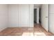 Bedroom with closet doors and tiled flooring, with a doorway leading to the bathroom at 5952 W Coronado Rd, Phoenix, AZ 85035