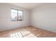 Bedroom features tile flooring, neutral paint throughout, and a window at 5952 W Coronado Rd, Phoenix, AZ 85035