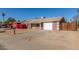 Suburban house features a simple front yard, garage, and low-maintenance desert landscaping at 5952 W Coronado Rd, Phoenix, AZ 85035