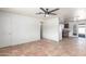 Spacious open concept living room with tiled flooring that flows into the kitchen area at 5952 W Coronado Rd, Phoenix, AZ 85035