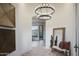 Bright and airy foyer with a chandelier and views through to the mountain in the background at 6038 E Agave Cir, Carefree, AZ 85377