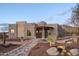 Inviting home featuring a beautiful desert landscape and charming architectural details at 6038 E Agave Cir, Carefree, AZ 85377