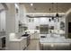 Modern white kitchen featuring a large island, stainless steel appliances, and a barrel brick ceiling at 6038 E Agave Cir, Carefree, AZ 85377