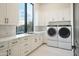 Bright laundry room with modern appliances, ample cabinet space, and a large window with picturesque views at 6038 E Agave Cir, Carefree, AZ 85377