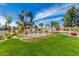 Beautiful community entrance with a waterfall feature, lush landscaping, and a globe statue at 628 Leisure World --, Mesa, AZ 85206