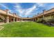 Beautiful courtyard with a fountain and green lawn area surrounded by a building with covered walkways at 628 Leisure World --, Mesa, AZ 85206