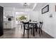 Bright dining area adjacent to kitchen features black table and chairs, and a view to the sunroom at 628 Leisure World --, Mesa, AZ 85206