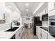 Bright kitchen features white cabinetry, modern appliances, a black faucet, and an adjacent dining area at 628 Leisure World --, Mesa, AZ 85206