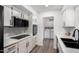 Bright kitchen features white cabinetry, modern appliances, a black faucet, and a laundry area at 628 Leisure World --, Mesa, AZ 85206