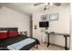 Cozy bedroom featuring tiled floor, ceiling fan, a small desk and simple decor at 7006 N 14Th Ave, Phoenix, AZ 85021