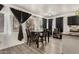 Bright dining area featuring modern floors, a dining table, and natural light from the window at 7006 N 14Th Ave, Phoenix, AZ 85021