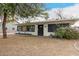 Charming single-story home with manicured lawn, blooming bougainvillea, and a welcoming front porch at 7006 N 14Th Ave, Phoenix, AZ 85021