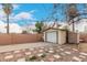 Detached one car garage with a concrete driveway, storage shed and secure backyard fencing at 7006 N 14Th Ave, Phoenix, AZ 85021