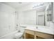 Bathroom featuring a shower-tub combo, large mirror, and neutral-toned vanity at 7557 W Colter St, Glendale, AZ 85303