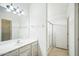 Neutral-toned bathroom features a shower-tub combo, sleek vanity, and modern lighting at 7557 W Colter St, Glendale, AZ 85303