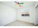 This bright bedroom features a colorful ceiling fan and a window overlooking the neighborhood at 7557 W Colter St, Glendale, AZ 85303