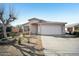 Charming single-story home with a tile roof, desert landscaping, and a two-car garage at 7557 W Colter St, Glendale, AZ 85303